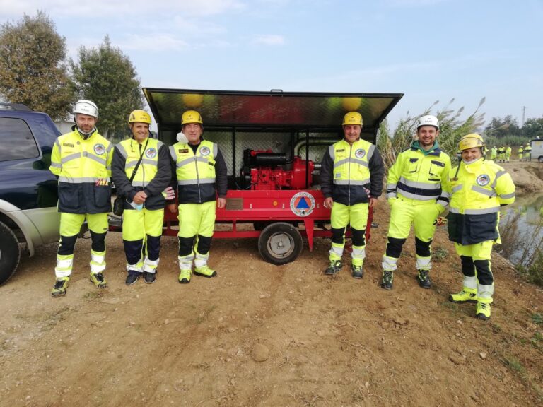Sei volontari in divisa schierati davanti al carrello con la motopompa, durante un'esercitazione